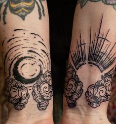 two people with tattoos on their arms and hands, both have sun rays coming out of them