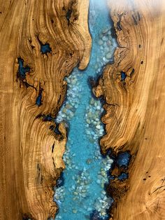 a wooden table with blue water in it