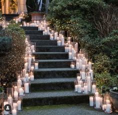 many candles are lit on the steps outside