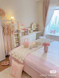 a pink and white bedroom with lots of clothes