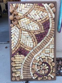 a wine cork art is displayed on the sidewalk