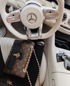 a purse sitting on top of a car steering wheel