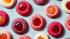 colorful pastries with jelly and an egg in the middle on a blue tablecloth