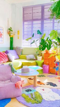 a living room filled with lots of colorful furniture and plants on top of the rugs