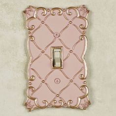 The solid color resin Angelitta Decorative Switchplates feature dimensional diamond latticework and scrolls with handpainted touches of gold. Paint-tipped screws are included. Single Switch is 3.5"Wx5.5"H. Double Switch is 5.25"Wx5.25"H. Single Outlet (two sockets) is 3.5"Wx5.25"H. Single Dimmer/Rocker is 3.5"Wx5.5"H.  Do not over-tighten the screws.     This item is our exclusive!   Choose from four switchplate styles   Specify Cream, Green, Pink, or Purple   Decorative switchplates have diamon Gold And Pink Room Decor, Vintage Pink Room Decor, Soft Pink Decor, Cool Light Switch Covers, Cute Outlet Covers, Pretty Light Switch Covers, Pink And Gold Bathroom Ideas, Pink And Gold Bedroom Decor, Pink And Green Apartment