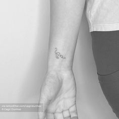 a person with a small tattoo on their wrist