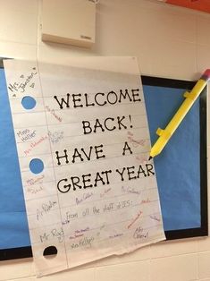 a bulletin board with writing on it and a yellow pencil sticking out of the back