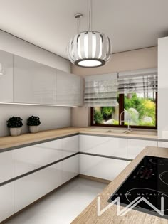 a modern kitchen with white cabinets and wood counter tops, an island style stovetop