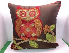 an owl is sitting on a tree branch pillow