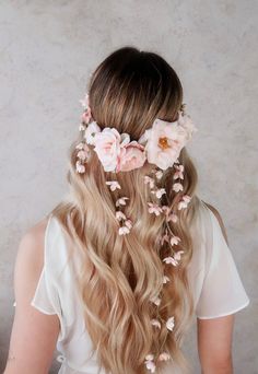 a woman with long blonde hair and flowers in her hair