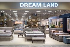 a store filled with lots of different types of couches and chairs in front of a sign that says dream land