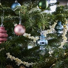 ornaments are hanging from the branches of a christmas tree