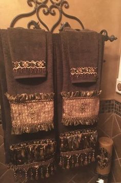 two brown towels hanging on the wall in a bathroom