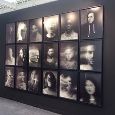 a black and white photo of people on display in an art gallery with multiple frames