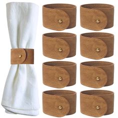 six pairs of brown leather cuffs with gold buttons on each side and one pair of white