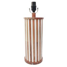 a brown and white striped trash can with a microphone attached to the top of it