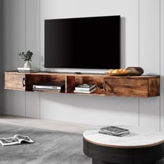 a flat screen tv sitting on top of a wooden shelf