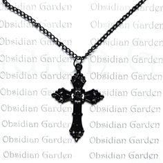 Gothic black ornate cross pendant necklace. All black with black enamel coating. Solid black plated chain with lobster clasp fastening. Chain length 60cm/23 1/2 inches. Pendant 60 x 32mm (measurements are approximate). On dispatch this item will be carefully wrapped in tissue paper before being sent in a padded envelope for extra protection. Free delivery in the UK. NOT SUITABLE FOR CHILDREN UNDER 5 YEARS. NOT SUITABLE FOR CHILDREN UNDER 5 YEARS. Ornate Cross, Black Plates, Cross Pendant Necklace, Black Enamel, Cross Pendant, Chain Lengths, Chain Length, Tissue Paper, Solid Black