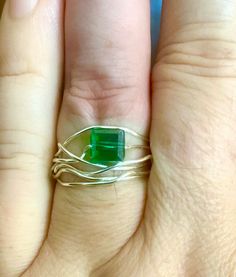 This unique handcrafted ring features an elegant silver wire design. The design is accentuated by the silver wire and green cube crystal bead accent, creating a piece that is eye-catching. This ring is a tarnish-resistant size 8 and offers both style and comfort. Whether you're treating yourself or looking for the perfect gift, this silver wire ring is sure to impress. Diy Wire Wrapped Ring, Silver Wire Rings, Wire Wrap Ring, Wire Wrapping Diy, San Dimas, Wire Design, Wire Wrapped Ring, Wire Ring, Wrap Ring