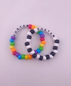 These custom kandi singles are perfect for any kandi kid, scene lover, or rave goer! Every bracelet is completely customizable, which means that you get to decide sizing, colors, letters, and numbers!  All bracelets are made with cloth-covered stretch cord, which assures that your jewlery will stretch nicely around the hand. the cloth covering will keep the quality at top shape for as long as possible, and prevent any wear and tear. Customization Instructions All available bead colors are listed in the images above. Please indicate which color beads you'd like within the note of your order. Please also indicate which string color you'd like.  BE SPECIFIC! Include color order, pattern, or any extra customization instructions with as much detail as possible. Letter and Number Beads  All word Customizable Novelty White Jewelry, Customizable White Novelty Jewelry, White Customizable Novelty Jewelry, Rainbow Beaded Bracelets For Rave And Friendship, Rainbow Beaded Bracelets For Friendship Rave, Rainbow Beaded Bracelets For Friendship, Rainbow Adjustable Beaded Bracelets For Rave, Adjustable Rainbow Beaded Bracelets For Rave, Customizable Adjustable Rainbow Jewelry