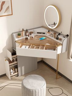 a white vanity with drawers and a mirror on the wall next to a round stool