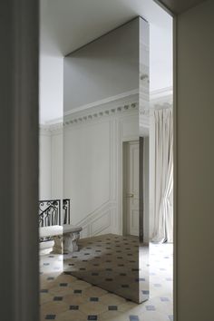 an empty room with a mirror reflecting it's reflection in the floor and walls