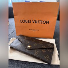 Just Replaced The Button Closure At The Louis Vuitton Store On Rodeo Drive, So Now It’s Brand New. There Is Some Wear On The Ends Of The Wallet, Refer To The Pics. Comes With The Bag & Pouch. Smoke Free Home! Designer Travel Wallet In Envelope Shape, Designer Envelope Wallet For Travel, Designer Travel Envelope Wallet, Elegant Monogram Canvas Wallet Gift, Louis Vuitton Sarah Wallet, Louis Vuitton Store, Bags Louis Vuitton, Rodeo Drive, Louis Vuitton Brown