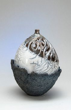 a small vase sitting on top of a rock