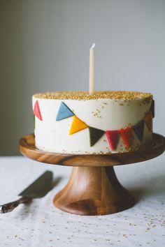 a birthday cake sitting on top of a wooden plate