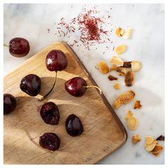 cherries on a wooden cutting board with dried cherries