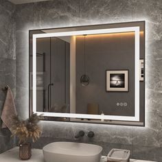 a bathroom with a sink, mirror and lights on the wall above it's counter