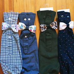 four different types of bow ties laid out on a wooden surface, one is green and the other is blue