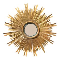 a gold sunburst mirror on a white background