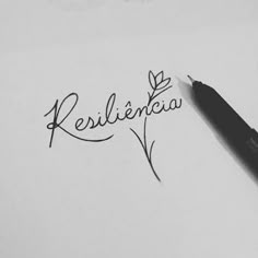 the word resilicia written in cursive writing next to a black pen