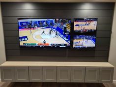 two large televisions mounted on the wall above a bench in a basketball game room