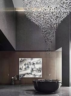 a large crystal chandelier hanging from the ceiling in a room with black walls