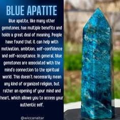 a large blue crystal on top of a table next to a sign that says, blue apatite