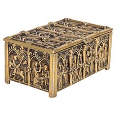 an intricately carved wooden box with figures on it