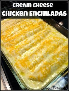 a cheesy chicken enchiladas in a glass baking dish on top of an oven