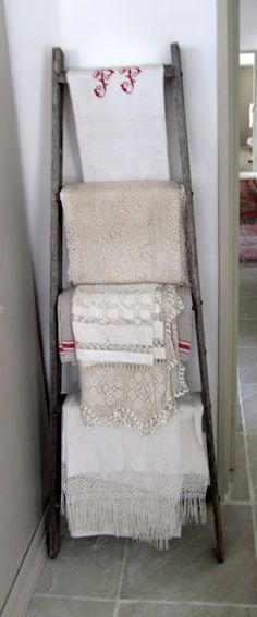 a ladder leaning against a wall with towels on it