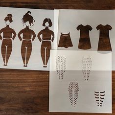 paper cutouts depicting different types of clothing on a wooden table with scissors and tape