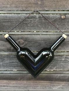 a black heart shaped balloon hanging on a wooden wall