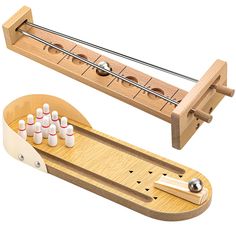 a wooden contraption with several different types of threading needles and pins in it