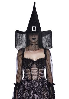 a woman wearing a witches hat and dress