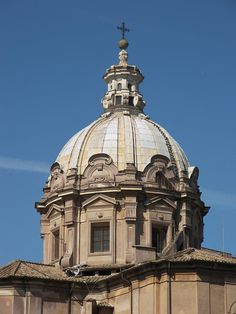 the top of an old building with a cross on it