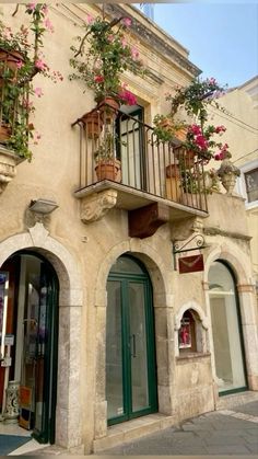 an old building with flowers on the balconies