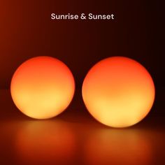 two orange balls sitting on top of a table next to each other with the words sunrise and sunset above them