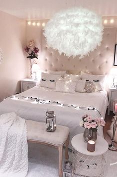 a bedroom with white furniture and lights on the ceiling