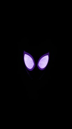 an alien face glowing in the dark with purple light on it's eyes and nose