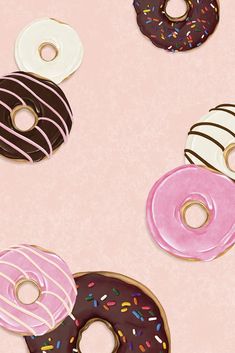 four donuts with different toppings on a pink background